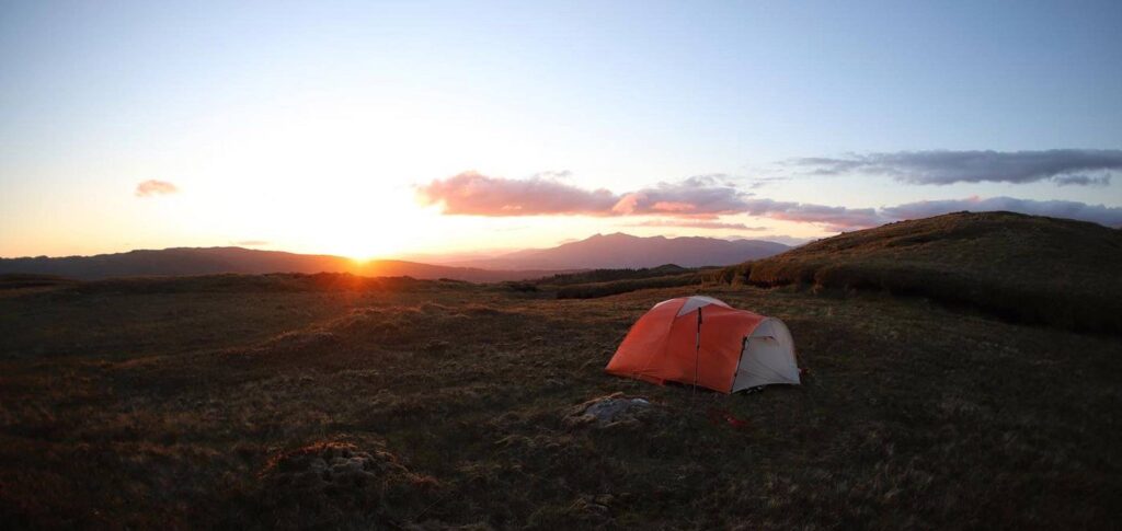 wild camping with a sunset