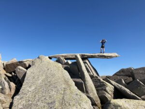 Monica standing on a stone ledge