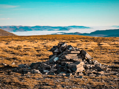 Summit cairn on the vast Geal-Charn plateau.